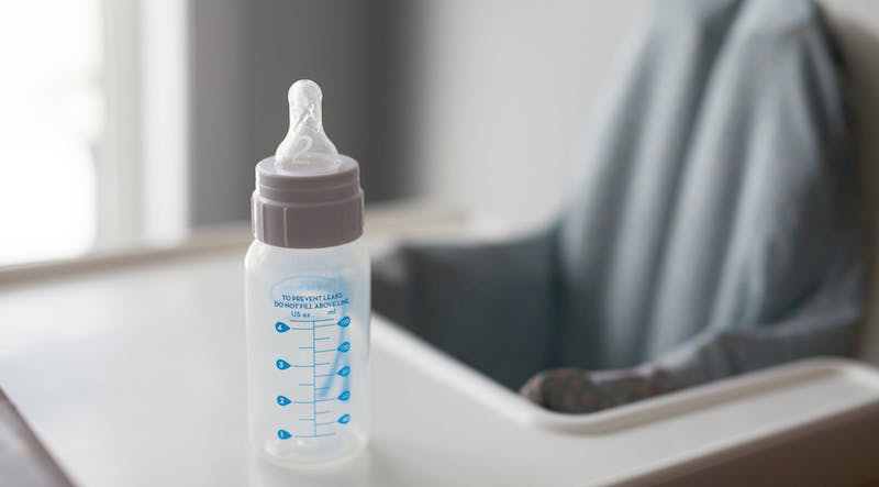 empty bottle sitting on an empty high chair